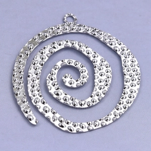 Macro view of a silver spiral pendant featuring a hammered texture on 304 stainless steel