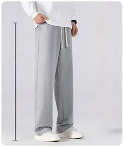 Detail of grey men's casual joggers showing elastic waistband and white drawstring