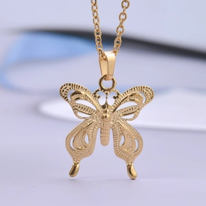 Close-up of 18k gold plated butterfly pendant with detailed hollow craftsmanship