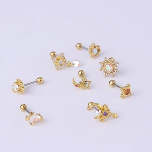 Detail of gold ear studs featuring moon and star shapes with colorful zircon stones