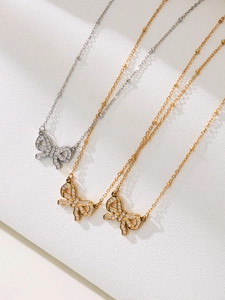 Macro detail of sparkling bow pendant necklace set with crystal diamond embellishments