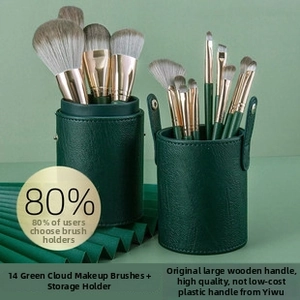 Close-up of 14-piece green makeup brush set with premium wood handles and leather storage case
