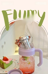 Detail of high borosilicate glass tea cup with lavender handle and stainless steel filter