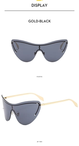 Detail view of GOLD-BLACK frameless butterfly sunglasses with sleek metal temples