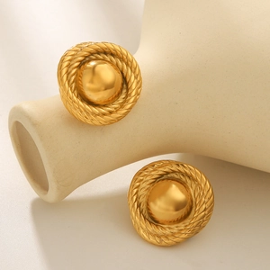 Detailed close-up of 18k gold plated round twisted rope earrings on a minimalist background