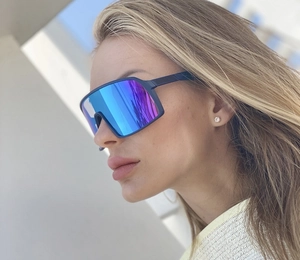 Cycling sunglasses detail showing the blue polarized lens on a side-view model shot