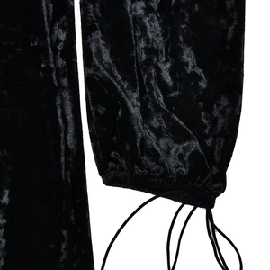 Detailed close-up of black velvet dress sleeve with elastic cuff and drawstring ties