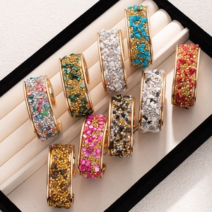 Golden open cuff bracelets with colorful natural stones and sparkling crystal inlay