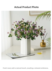 Faux purple roses in a white ribbed ceramic vase for elegant home decor and centerpieces