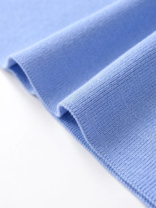 Close-up of the light blue knitted fabric showing soft texture and fine ribbed details