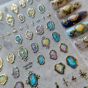 Detail of vintage 5D embossed gold-framed nail art stickers with iridescent gemstone effects