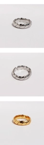 Detailed views of gold and silver plated twisted wave rings with an open adjustable band
