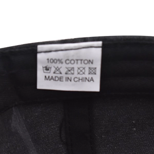 Detail view of the 100% cotton wash label and inner stitching on black baseball cap