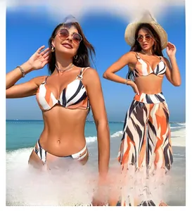 Detailed view of women's 3-piece bikini set with abstract orange and black stripe patterns