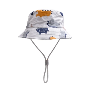Detail of white cotton kids sun hat featuring colorful cartoon dinosaur prints and chin strap