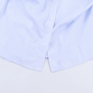Classic light blue plaid shirt hem with white buttons and detailed fabric texture