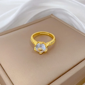 Adjustable gold plated heart shaped zircon ring with pavé side stones on silk background