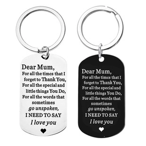 Close-up of silver and black stainless steel dog tag keychains with engraved message for Mom