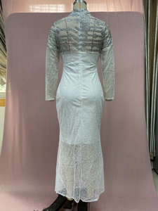 Detail of white slim dress showing silver sequin wave patterns on back and sleeves