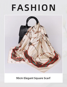Detail of 90cm vintage print silk scarf tied on a luxury black leather handbag handle