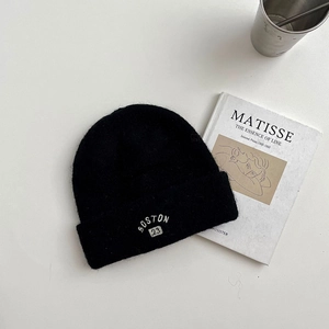 Detail of black wool knit beanie featuring white BOSTON 23 embroidery and soft texture