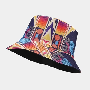 Detail view of retro bucket hat showing vibrant pop art cassette and radio patterns