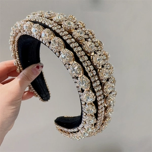 Detail view of the multi-row clear rhinestones on a gold-tone baroque sponge headband