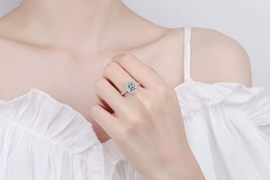 Close-up of model wearing 925 silver ring with oval moissanite and pavé set diamonds