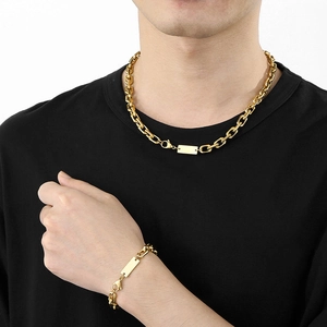 Men's gold stainless steel rectangle tag necklace and bracelet set on black t-shirt