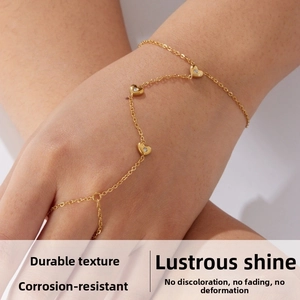 Detail view of a gold-plated stainless steel slave bracelet with sparkling heart charms