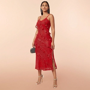 Detail of red sequin evening dress with ruffled layers and high side slit design