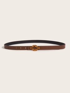 Detail of brown leather belt with elegant gold metal knot buckle on a beige background