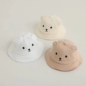 Detailed view of three cute baby sun hats with bear ears in white, beige and tan colors