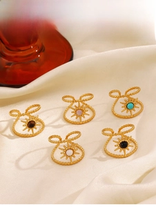 Detailed close-up of vintage gold starburst rings with colorful natural stones on silk