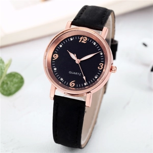 Macro shot of quartz watch with rose gold case, black leather strap and rhinestone dial