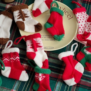 Mini knitted Christmas stockings with diverse festive patterns for tree decoration