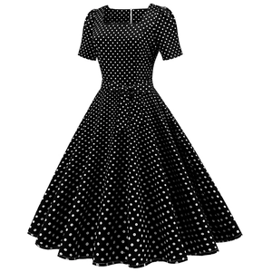 Detailed view of vintage black dress featuring white polka dots and a square neckline