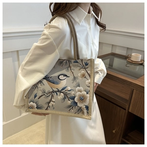 Linen tote bag featuring elegant bird and white floral prints with rope handles