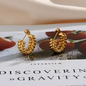 Macro view of 18K gold plated hoop earrings with an elegant twisted wheat pattern