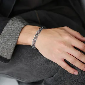 Close-up of dual-layer titanium steel chain bracelet with industrial OT buckle design