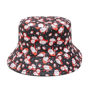 Detail of Christmas bucket hat with Santa Claus print on black twill cotton fabric
