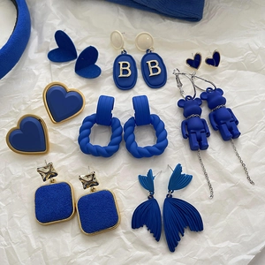Detailed collection of Klein blue earrings featuring heart, oval B, and bear pendant styles