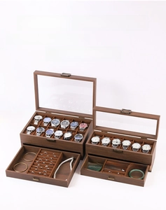 Detail view of walnut wood watch box with clear glass lid and vintage metal clasp