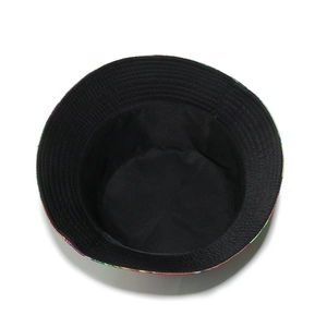 Detail of bucket hat interior showing black lining and colorful vegetable prints