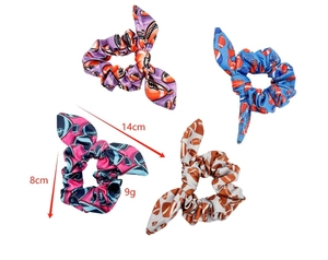 Detail of football pattern bow hair ties showing dimensions 14cm length and 8cm diameter