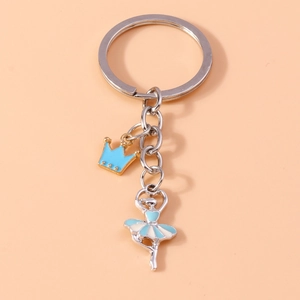 Close-up of ballet dancer pendant with blue enamel and golden crown on metal keychain