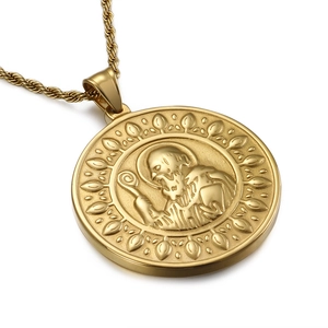 Gold St. Benedict cross pendant necklace with textured rope chain on white background