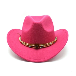 Detail of rose pink wool cowboy hat featuring bohemian beaded band and gemstone accent