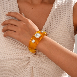 Detail view of vintage amber resin cuff bracelet with sparkling crystal rhinestones