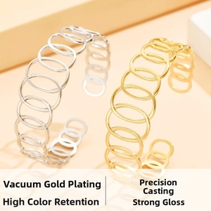 Detail of cutout geometric oval bangles in gold and silver finish with high polish